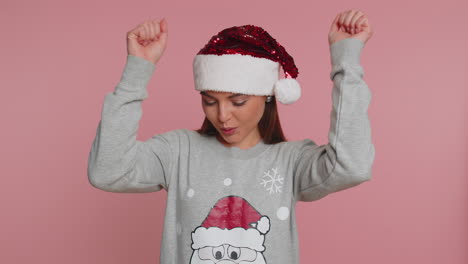 Christmas-woman-shouting,-raising-fists-in-gesture-I-did-it,-celebrating-success,-winning-lottery