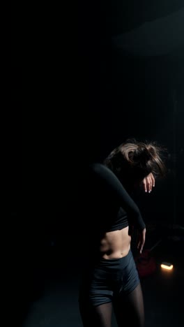 contemporary dance performance in a dark studio