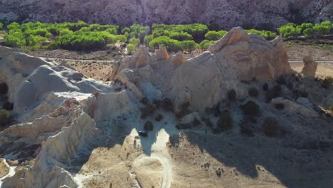 aerial view of jagged sedimentary rock formations on a sunny day