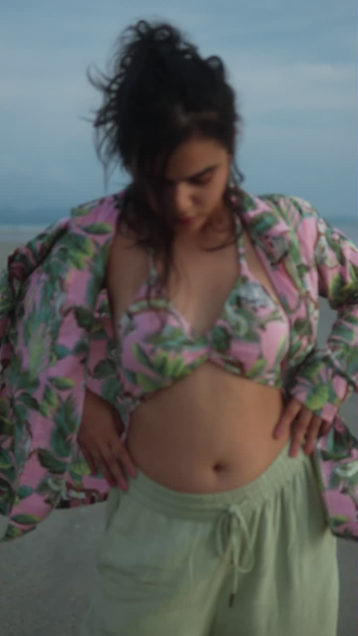 Beautiful Woman in Pink Bikini and Floral Shirt on the Beach