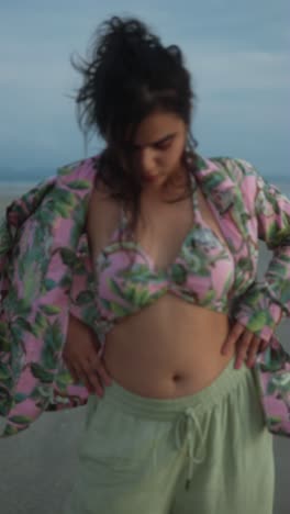 beautiful woman in pink bikini and floral shirt on the beach