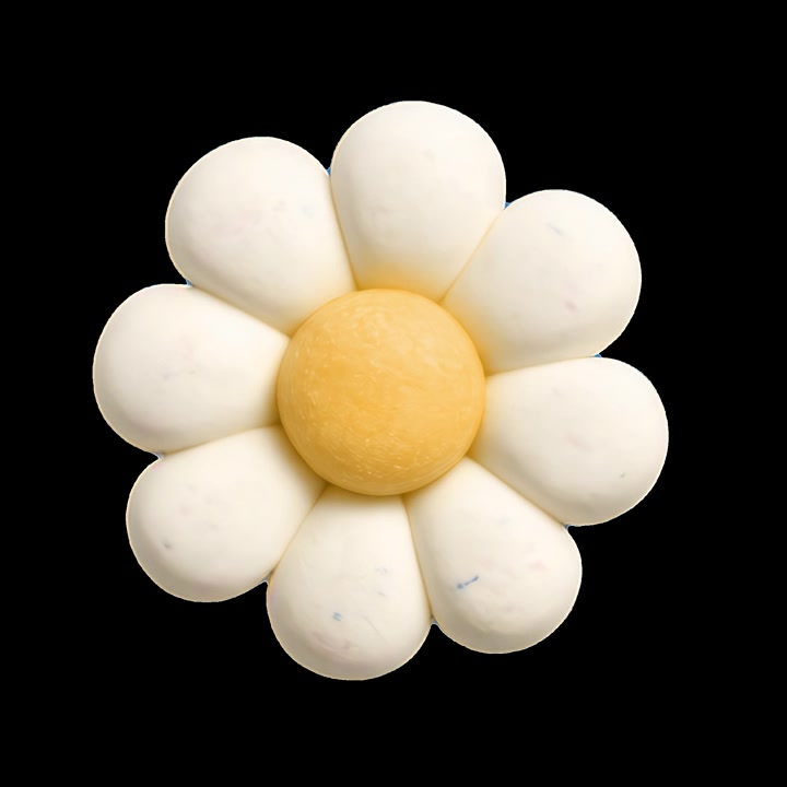 Rotating White Flower Shaped Confectionery on Black Background