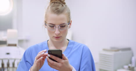 female doctor using mobile at healthcare clinic 4