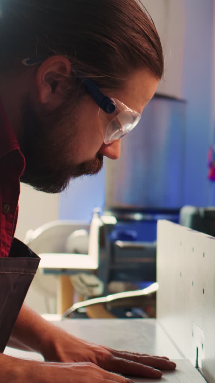 Craftsman Wearing Safety Glasses Operating Woodworking Machine