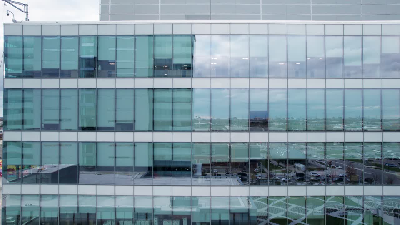 Drone Shot of Modern Curtain Wall Office Building Facade. Slow Pull Back, 4 Stories Visible