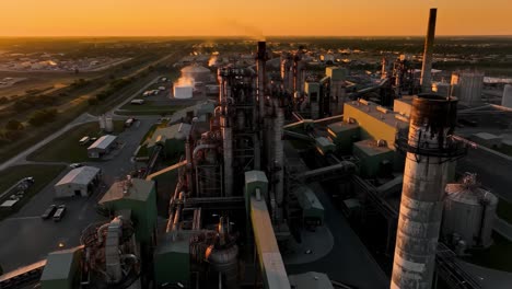 stunning aerial views of an industrial complex at sunset, showcasing the infrastructure and machinery contributing to energy production and manufacturing processes