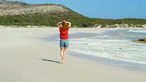 Woman-walking-on-beach-on-a-sunny-day-4k