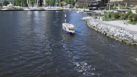 motorboat passes below in elizabeth quay perth,