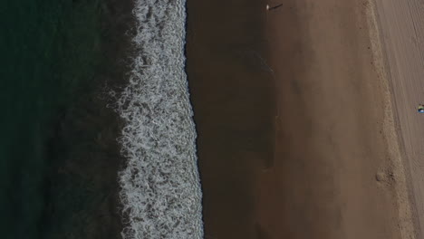 AERIAL:-Birdsview-on-waves,water-on-Beach-in-Los-Angeles,-California,-Sunny,-Blue-Sky