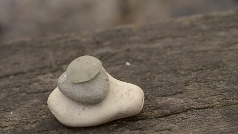 Zen-stones-at-waterfront-on-wooden-bridge