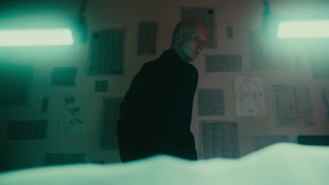 man in a room with papers on the wall