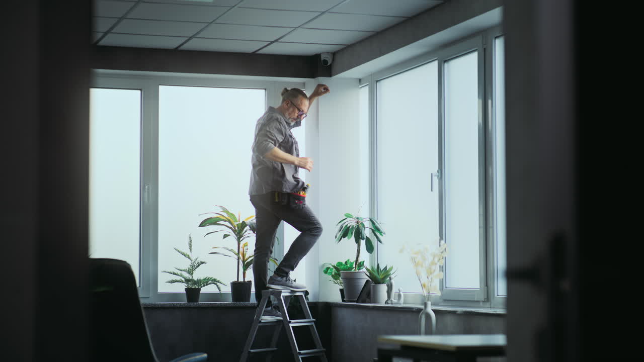 Man Installing Window Treatments