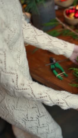 woman crafting a beautiful christmas wreath