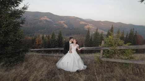 Newlyweds.-Caucasian-groom-with-bride-on-mountain-slope.-Wedding-couple.-Happy