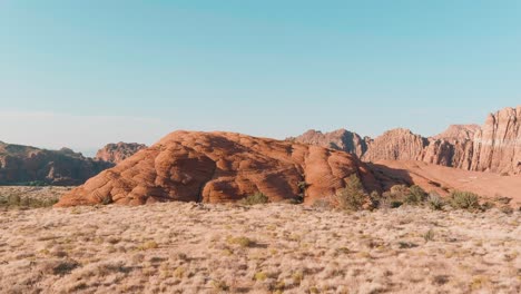 aerial pushing towards ancient lava flow mound in the desert