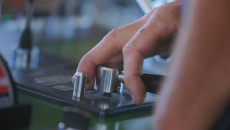 a man operating some buttons of a fishing boat in slowmotion