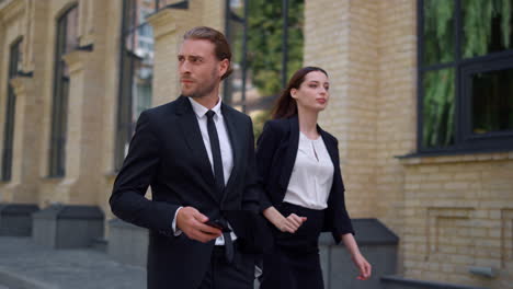 business man and woman walking to work