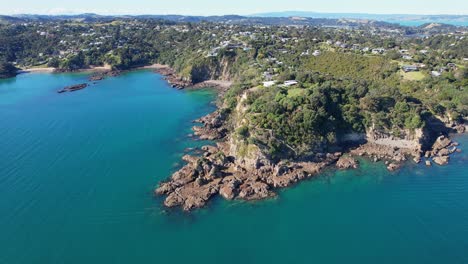 fishermans rock in oneroa, waiheke island, new zealand - aerial drone shot