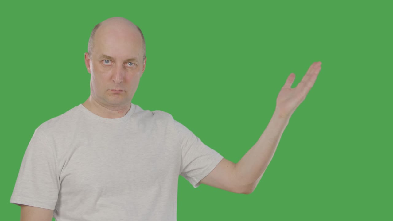 Confident middle aged man gesturing and presenting something on keyed green screen. Alpha channel