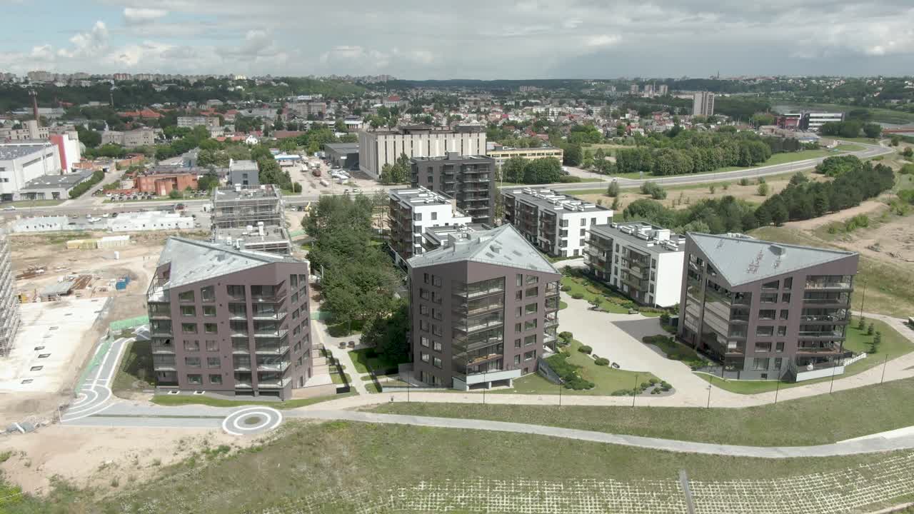 Beautiful ascending view of 3 apartment buildings in aerial drone shot