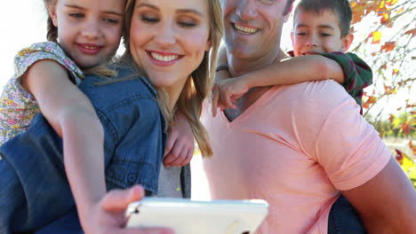 familia feliz tomando una selfie en el parque 4k