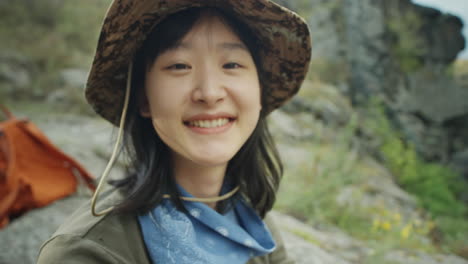 joyous asian tourist posing at campsite