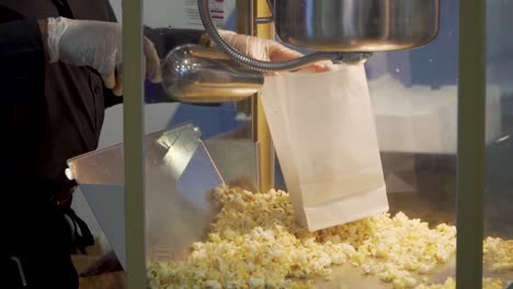 popcorn being scooped out of classic popcorn machine