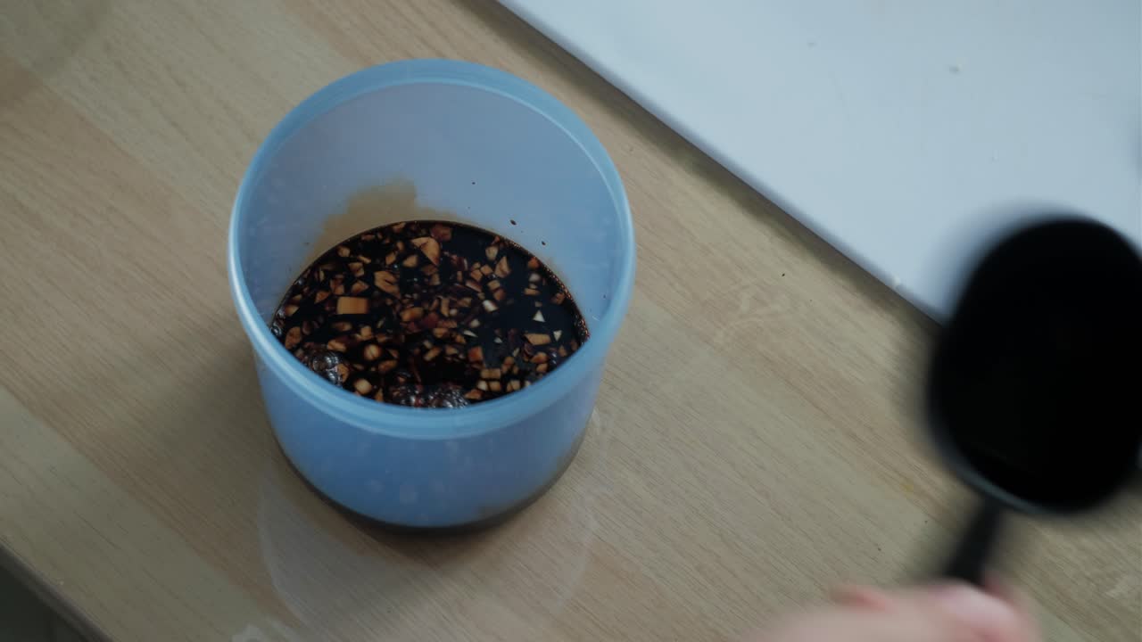Scooping Soy Sauce On Container With Minced Garlic. - closeup shot