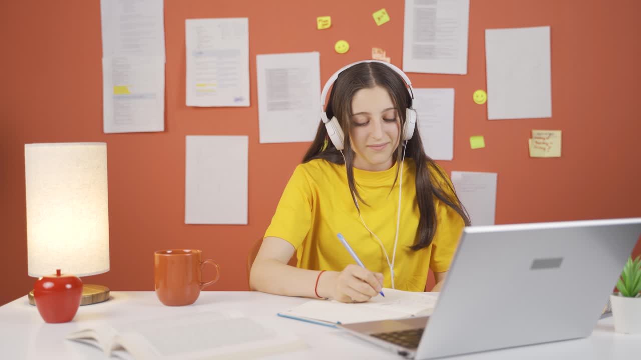 niña escuchando música con auriculares en casa