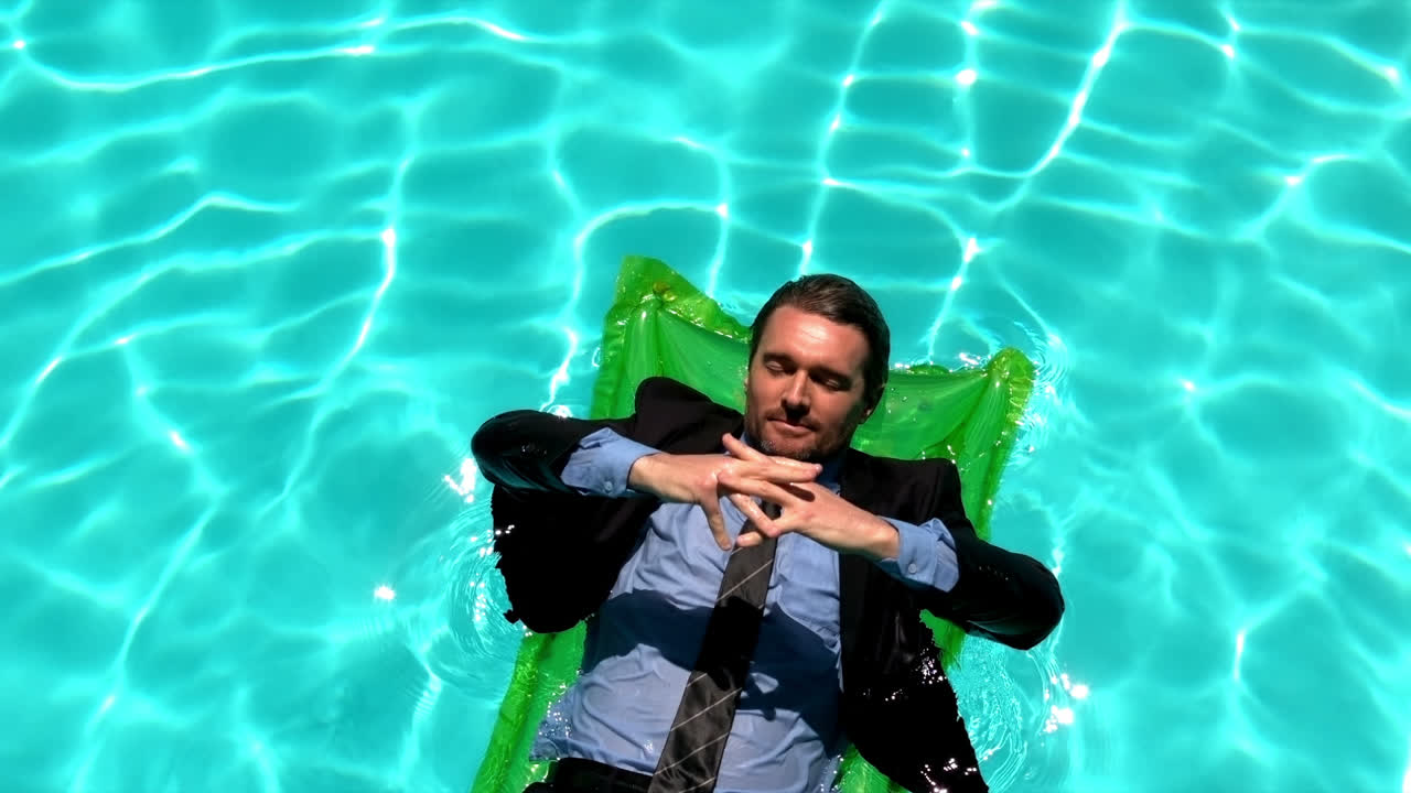 Businessman relaxing on air mattress