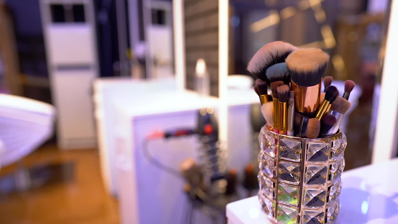 A set of brushes for makeup is on the table - slow motion 120 fps