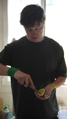 man cutting avocado