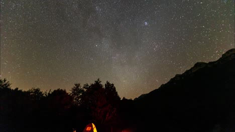 Night-to-day-time-lapse-camping-in-the-jungle-enjoy-travel-to-forest-national-park-in-Iran-mountain-pitch-tent-set-wood-fire-campfire-fathering-and-control-the-smoke-in-wide-panoramic-view-stargazing