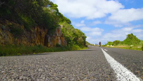 Female-cyclist-cycling-on-a-countryside-road-4k