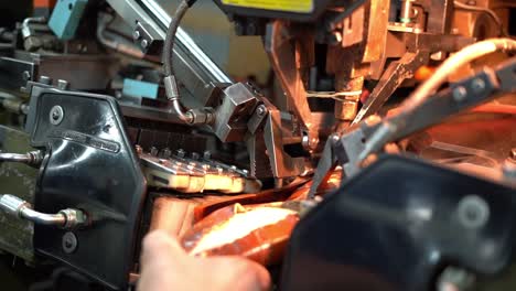 a craftsman handmade a shoe by a machine, close up shot, insert shot
