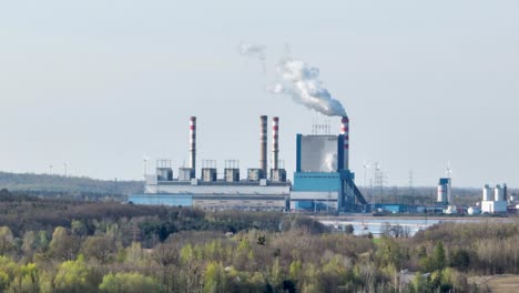 konin power plant station with smog white polluted smog released from chimney co2 zero emission plan great reset concept