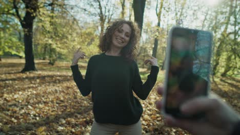 caucasian woman dancing and recording video for social media.