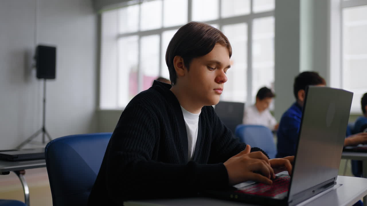 Students working on laptops in a classroom