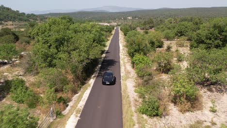 aerial back traveling over an electric car sunny day aerial south of france