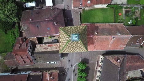 a stationary top-view aerial footage of the clock tower while showing the traffic that passes through it