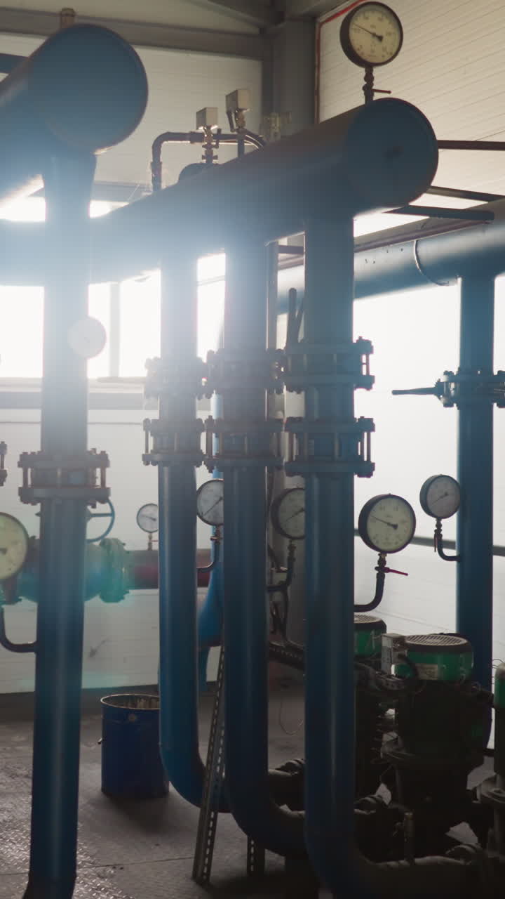 Hot steam transporting system with pipelines and compressors in mechanical room. Heat generating technology of boiler house. Pumping equipment