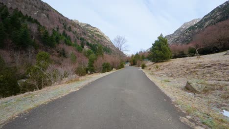 road trip going up the mountain in the pyrenees in catalonia camera located in front of the car snow on the road