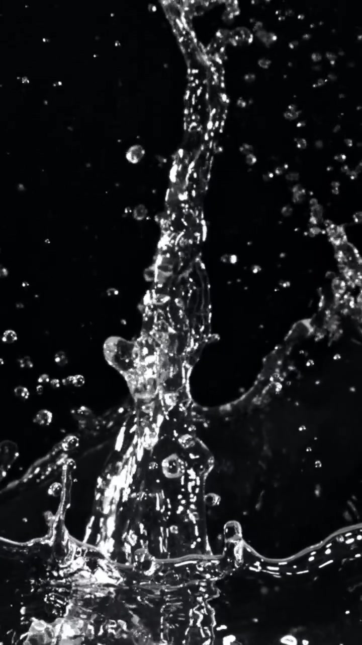 Slow Motion Water Splash with Droplets on Black Background