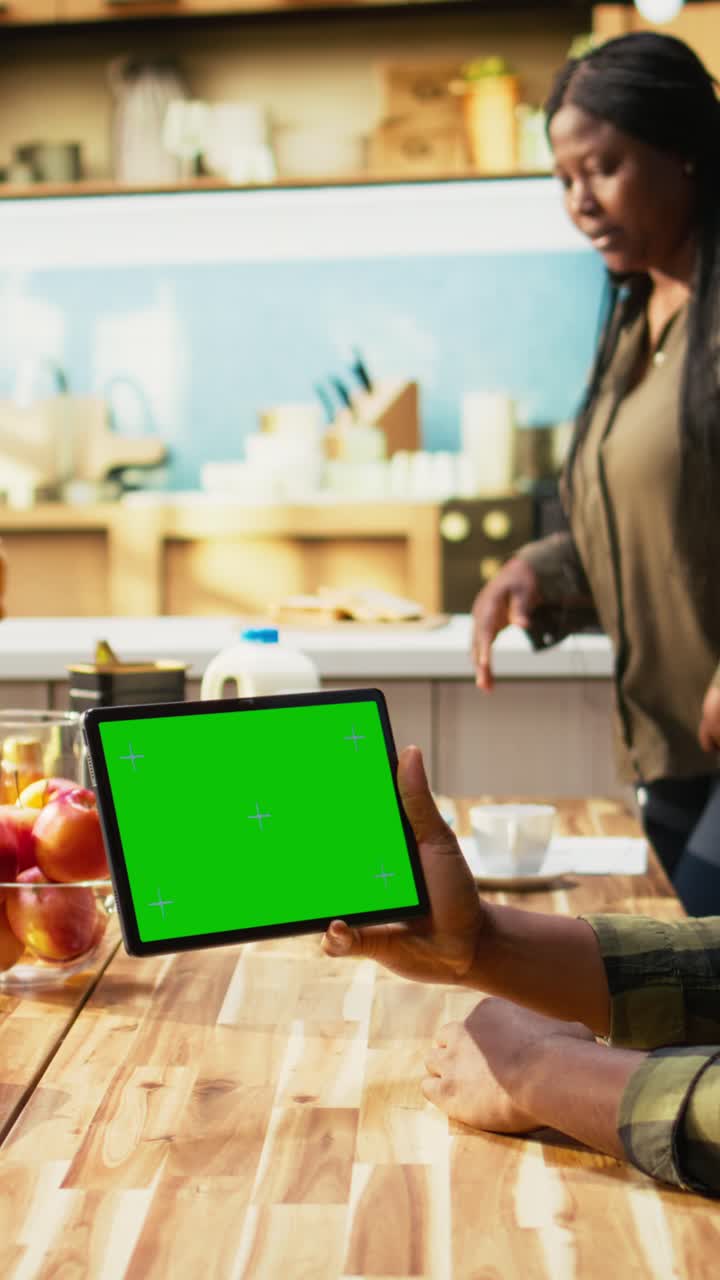 Vertical Video Chroma key display with family serving breakfast in a sunny kitchen
