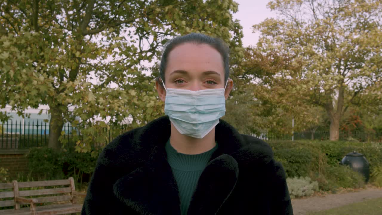 Female wearing a medial facemask whilst looking to camera