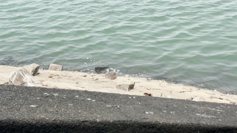 Looking-down-and-seeing-water-hitting-wall-of-Kabini-dam,-Mysore,-India