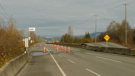 highway closure due to a flood, road destroyed in canada with traffic signs