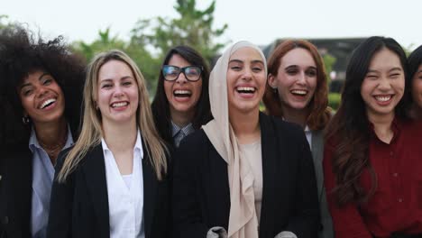 multiracial business women smiling on camera outdoor