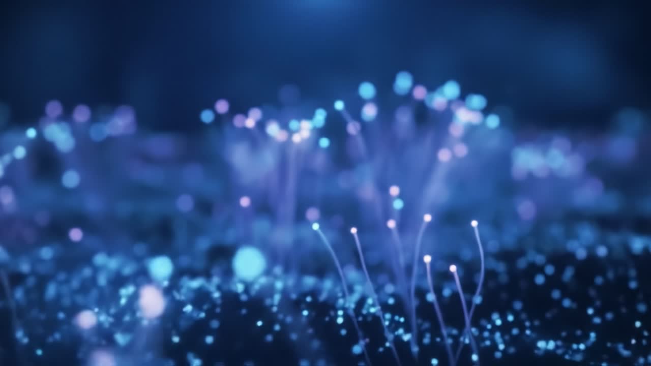 Mesmerizing patterns emerge in a deep blue environment as glowing particles dance and twirl, creating an enchanting visual experience. The rhythmic movement draws viewers into a dreamlike world.