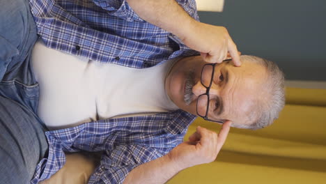 vertical video of old man showing mind to camera.